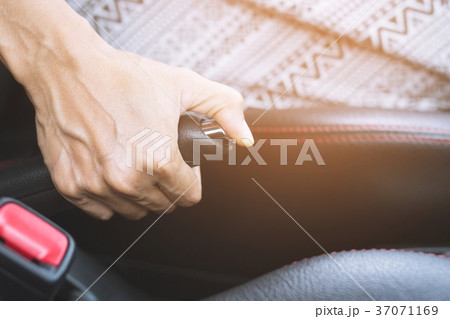 Closeup of person hand pulling handbrake  37071169