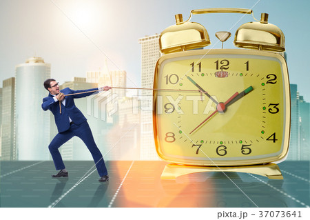 Businessman pulling clock in time management Businessman pulling clock in time management 37073641