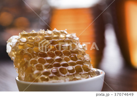Jar of honey with honeycomb 37074649