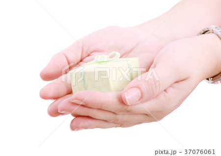 Female hands giving a gift. Isolated on white 37076061