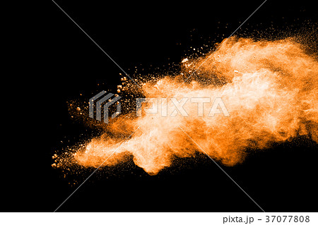abstract orange powder explosion on black. 37077808