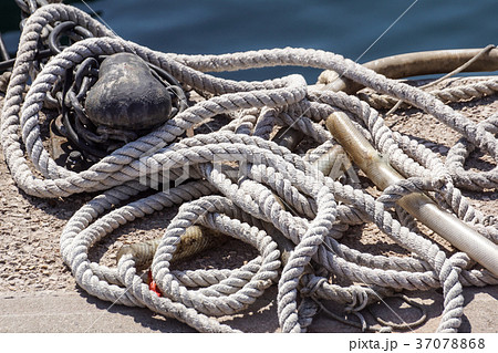 Old rusted mooring bollard with knotted nautical 37078868