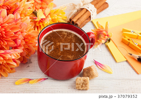 Cup of coffee with cinnamon, orange chrysanthemum 37079352