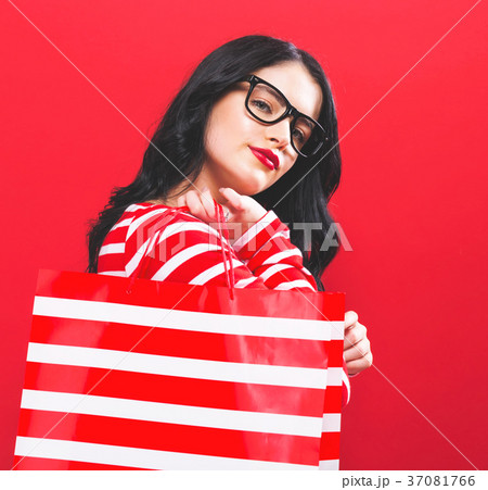 Young woman holding a shopping bag Young woman holding a shopping bag 37081766