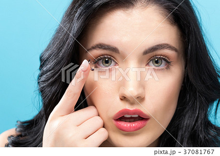 Beautiful young woman with contact lens Beautiful young woman with contact lens 37081767