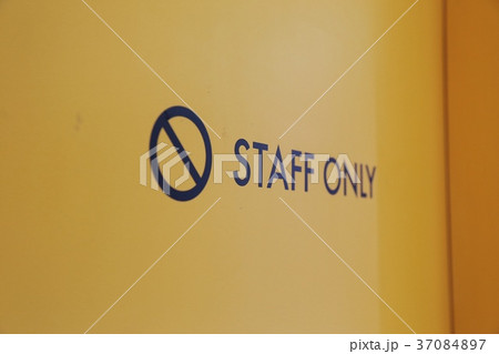 Staff only sign on the yellow entrance door  37084897