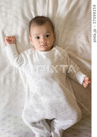 Portrait of a newborn Asian baby on the bed. Portrait of a newborn Asian baby on the bed. 37099359