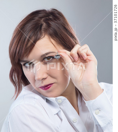 Portrait of woman showing earring Portrait of woman showing earring 37101726