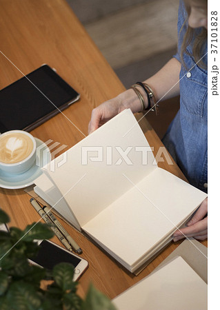 A young girl flips through a clean album. Flat lay 37101828