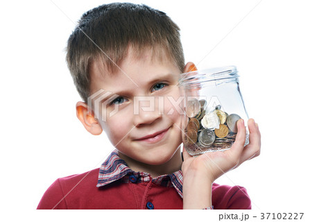Beautiful little boy with glass jar of coins isolated Beautiful little boy with glass jar of coins isolated 37102227
