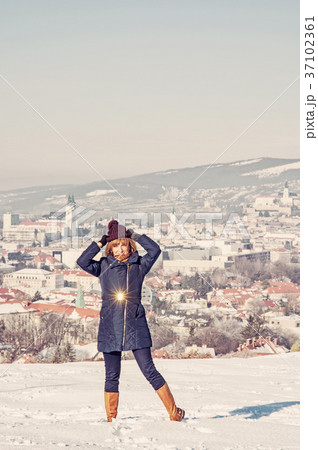 Positive woman posing in snowy landscape, filter 37102361