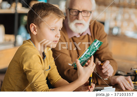 Serious smart boy learning to fix things 37103357