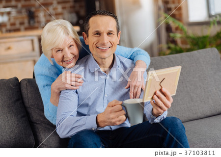 Happy mother and son posing while looking at Happy mother and son posing while looking at 37103811