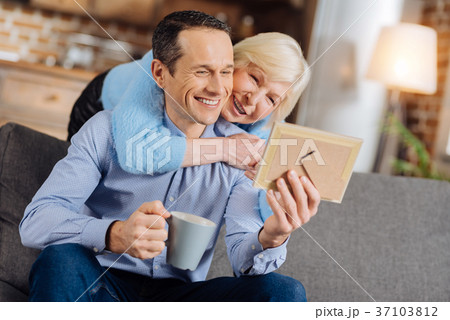 Loving mother hugging son looking his baby photo 37103812