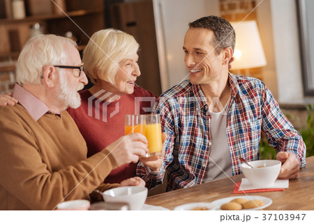 Senior woman watching her son and husband have 37103947