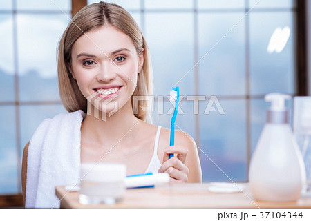 Adorable woman being about to brush her teeth 37104344