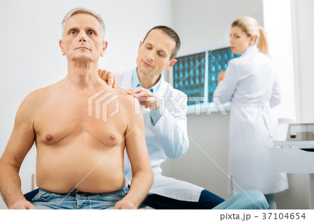 Smart male therapist working with his elderly 37104654