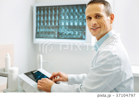 Experienced smart radiologist looking at you Experienced smart radiologist looking at you 37104797