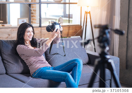 Cheerful happy woman sitting on the sofa Cheerful happy woman sitting on the sofa 37105308