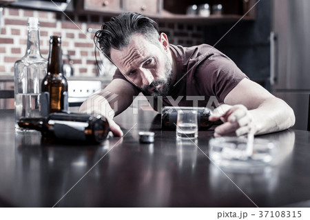 Cheerless drunk man waking up Cheerless drunk man waking up 37108315