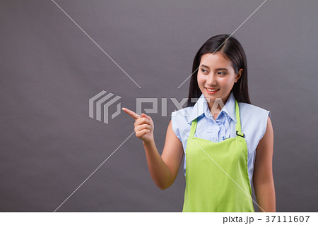 confident woman shopkeeper pointing up side way confident woman shopkeeper pointing up side way 37111607