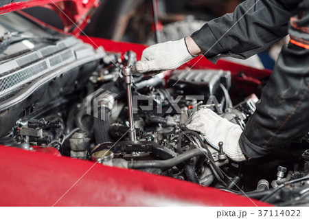 Repairing of modern diesel engine, workers hands 37114022