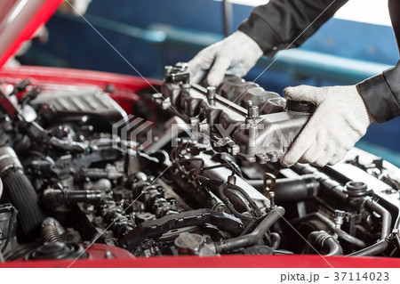 Repairing of modern diesel engine, workers hands 37114023