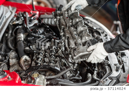 Repairing of modern diesel engine, workers hands 37114024