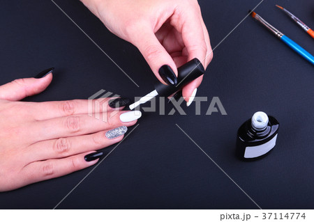 Black, white Nail art manicure. Holiday style Black, white Nail art manicure. Holiday style 37114774