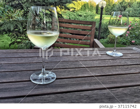 wine glasses on a wooden table at garden wine glasses on a wooden table at garden 37115742