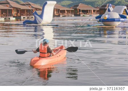 young woman in orange life jackets kayaking lake 37116307