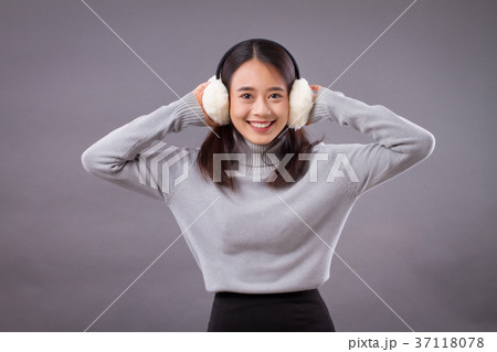 happy smiling asian woman with earmuffs 37118078