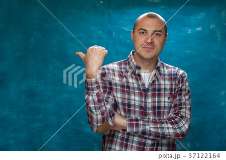 Happy positive man in plaid shirt posing 37122164