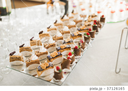 Delicious sweets on wedding candy buffet with Delicious sweets on wedding candy buffet with 37126165