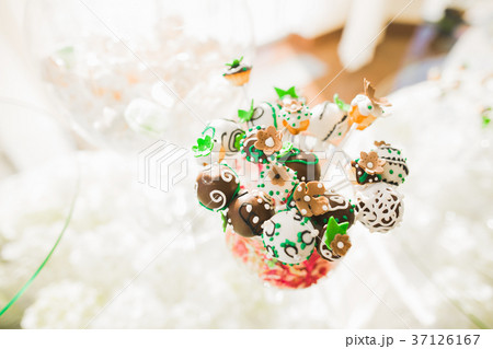 Delicious and tasty dessert table with cupcakes Delicious and tasty dessert table with cupcakes 37126167
