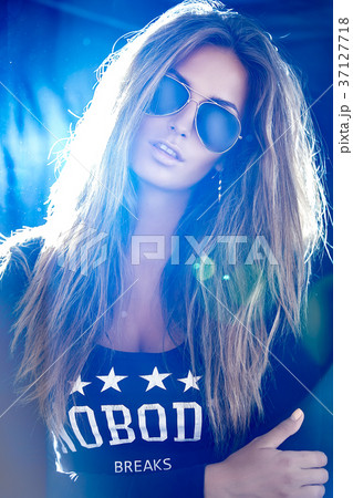 Elegant blonde woman in black shirt with stars Elegant blonde woman in black shirt with stars 37127718