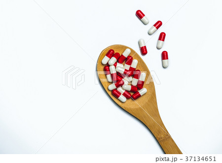 antibiotics capsule pills in wooden spoon  37134651