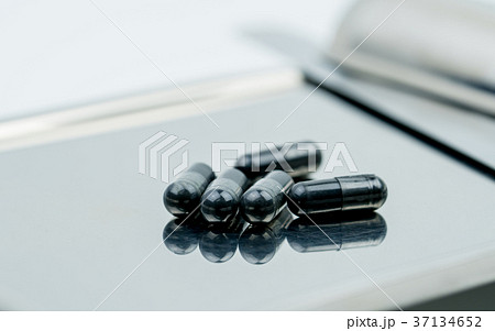 Activated charcoal capsule on drug tray 37134652