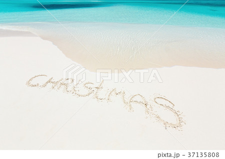 Handwritting inscription word CHRISTMAS on beach 37135808