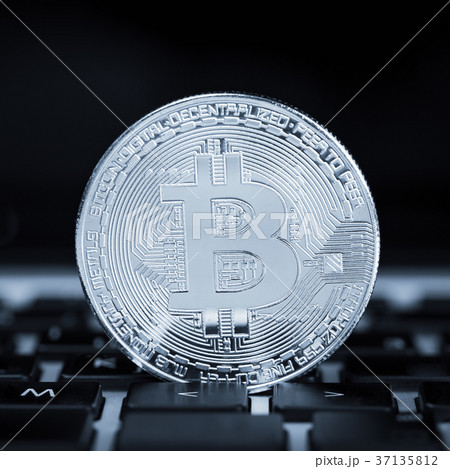 Bitcoin on laptop keyboard 37135812
