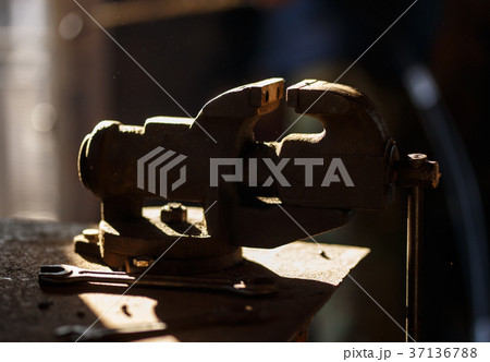 Blacksmith tools. Backlighted old vise in a forge 37136788