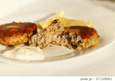Salmon fishcakes (cutlets) served with white sauce Salmon fishcakes (cutlets) served with white sauce 37138661