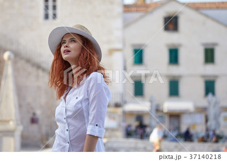 Portrait of a beautiful young female tourist in a summer vacatio Portrait of a beautiful young female tourist in a summer vacatio 37140218