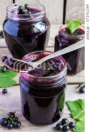 Black currant jam on a wooden background 37141194