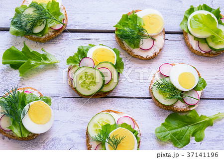 Fresh toast sandwiches with egg, radish, cucumber  37141196