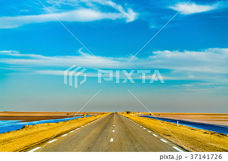 Highway through Chott el Djerid, a dry lake in Highway through Chott el Djerid, a dry lake in 37141726