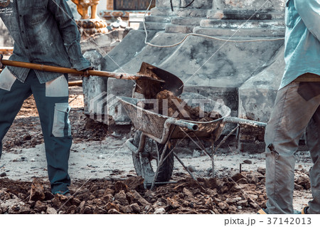 Workers carrying truck load of soil Workers carrying truck load of soil 37142013