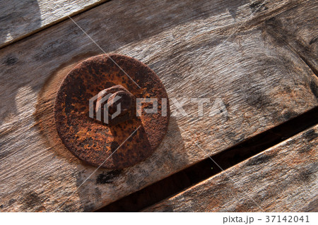 The screw nut is rust on old wood floor. The screw nut is rust on old wood floor. 37142041