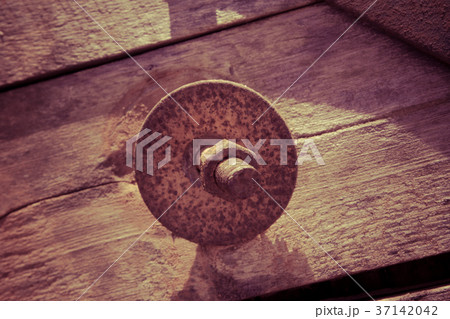 The screw nut is rust on old wood floor. The screw nut is rust on old wood floor. 37142042