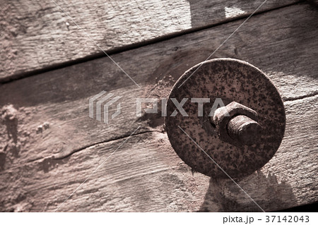 The screw nut is rust on old wood floor. The screw nut is rust on old wood floor. 37142043